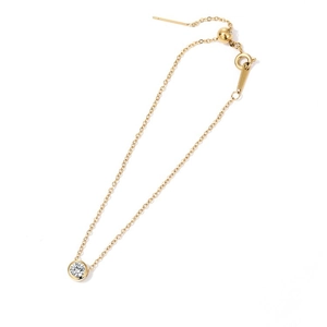 Detailed macro view of an adjustable gold stainless steel bracelet with round crystal