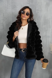 Close-up of black faux fur short jacket with bubble texture and metallic zip detail