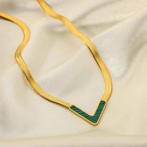 Golden flat snake chain necklace with a V-shaped pendant featuring green malachite inlay