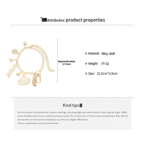 Detail view of beach style gold alloy bracelet with shell and starfish charms