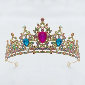 Detailed close-up of colorful rhinestones on a golden baroque bridal crown with pink gems