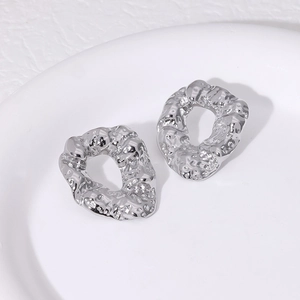 Minimalist silver irregular hammered round stud earrings with textured molten metal finish