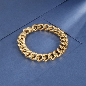 Detailed close-up of golden stainless steel Cuban link bracelet with textured clasp