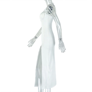 Side view of white slim fit maxi dress with high slit and sleeveless backless design