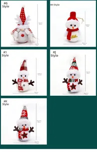 Detail of Christmas plush doll ornaments featuring festive gnomes and snowmen with gold cords