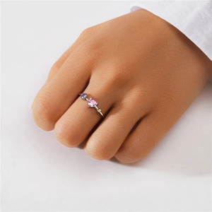 Detail of S925 silver ring featuring pink heart-shaped stone and colorful gems on finger