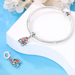 Detail of silver snake chain bracelet with heart clasp and colorful spider charms