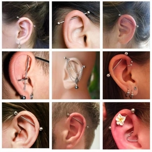 Multiple styles of titanium industrial barbell piercings with chains and floral charms