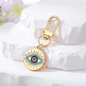 Vintage bohemian gold metal evil eye keychain with blue and black rhinestones