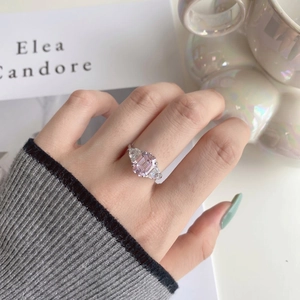 Macro detail of S925 silver ring featuring an emerald cut pink stone and side accents