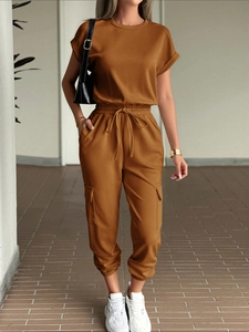 Detail shot of brown two-piece leisure set showing cargo pockets and drawstring waist