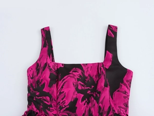 Detail of elegant jacquard dress fabric with pink floral pattern on a black background