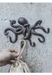 Detail eines Oktopus-Wandhakens aus vintage Gusseisen mit rustikaler Metallstruktur