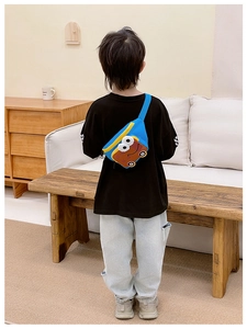 Detailed back view of a blue cartoon bread car crossbody bag worn by a child