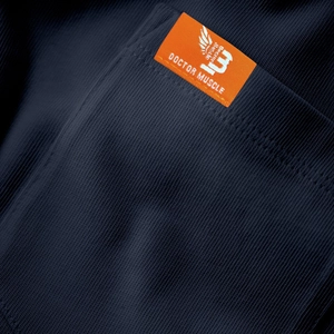 Detail of navy blue ribbed knit t-shirt featuring pocket edge and orange brand woven label