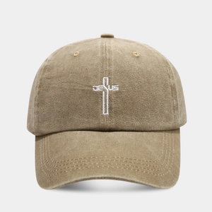 Detail of cross and JESUS embroidery on washed cotton baseball cap in khaki finish