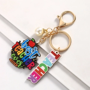 Detail of Best Teacher Ever keychain with colorful charms and elegant golden metal finish