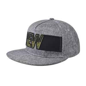 Flat brim baseball cap in heather grey featuring yellow NEW embroidery and a rectangle patch