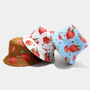 Detailed macro showing fruit print bucket hats in coffee, white and blue variants