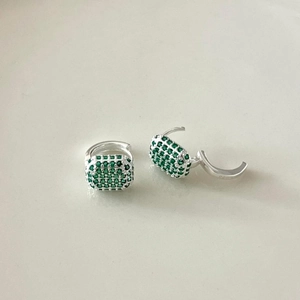 Detailed close-up of S925 sterling silver huggie earrings with square green zircon pendants