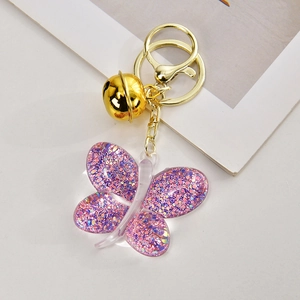 Cute purple acrylic butterfly keychain with colorful sequins and golden bell charm