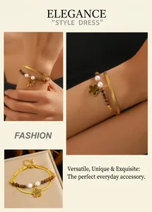 Macro detail of a double-layer bracelet with tiger eye beads and a gold clover charm