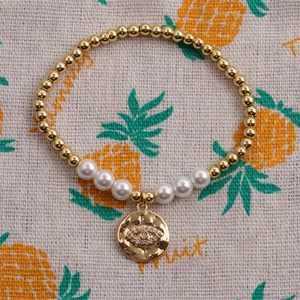 Bracciale elastico in perline dorate e perle con ciondolo occhio del male in zirconi