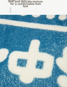 Detail of blue plush halloween mat showing dense soft fiber texture and white patterns
