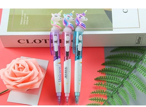 Detailed view of creative unicorn glowing pens in purple, pink and blue pastel colors
