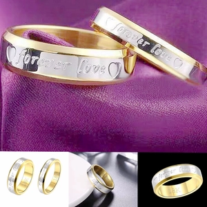 Close-up of Forever Love engraved titanium steel couple rings with 18K gold markers
