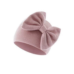 Detail of the soft ribbed knit texture and large bow on the infant warm beanie
