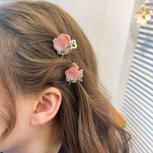 Pink glitter rose flower hair claw clips for women shown on model for elegant hairstyle