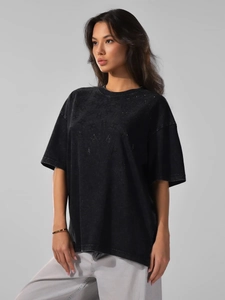 Detailed view of washed charcoal cotton fabric and rhinestone branding on retro t-shirt