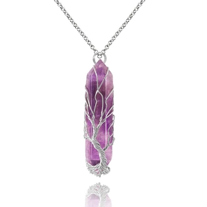 Macro detail of purple amethyst hexagonal pendant with handcrafted silver wire tree of life