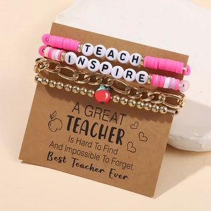 Close-up of a 4-piece pink and gold teacher gift bracelet set featuring Inspire beads