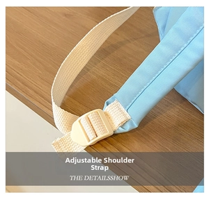 Close-up of adjustable cream woven straps and plastic buckles on a blue kid backpack