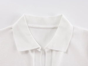 Detailed shot of a white cotton polo shirt collar with premium fabric texture