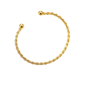 Minimalist twisted rope cuff bracelet in gold finish with spherical end caps on white background