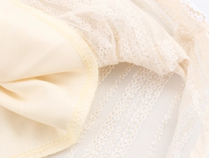 Detail shot of beige knit dress showing double-layer fabric with fine mesh and lining