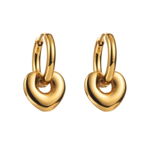 Close-up of golden stainless steel hoop earrings with polished heart-shaped pendants