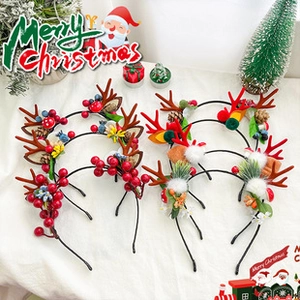 Detail of Christmas headband with red berries, pine cones and festive ornaments