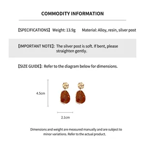 Macro detail of irregular gold and amber resin earrings with 4.5cm size measurement