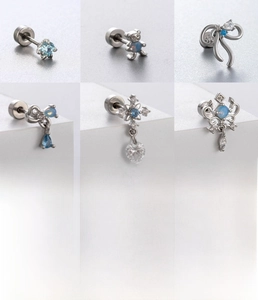 Detailed set of silver titanium steel cartilage studs with bow and zircon butterfly charms