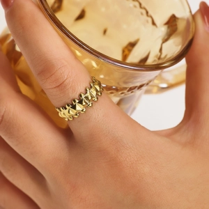 Chic gold-plated C-shaped ring with rivet texture shown in a lifestyle close-up shot