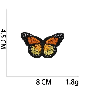 Detail view of butterfly embroidery patch with size dimensions 8cm by 4.5cm on white backdrop