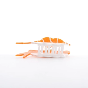 Macro detail of creative salmon sushi hair claw clip with realistic orange and white textures
