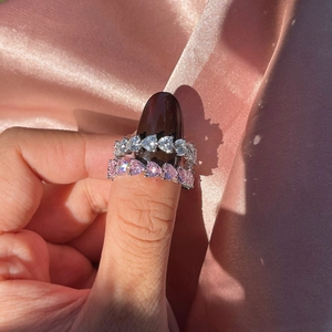Close-up of S925 silver eternity rings with pink and clear heart-cut cubic zirconia