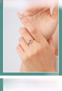 Close-up of s925 silver ring featuring an oval pink tourmaline gemstone on model hand