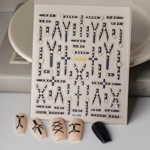 Macro detail of 5D embossed punk nail stickers featuring belts, rivets and silver crosses