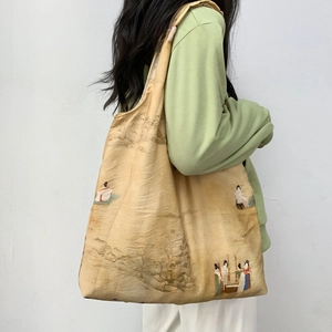 Detail of vintage canvas tote bag with traditional Chinese landscape print on light beige fabric